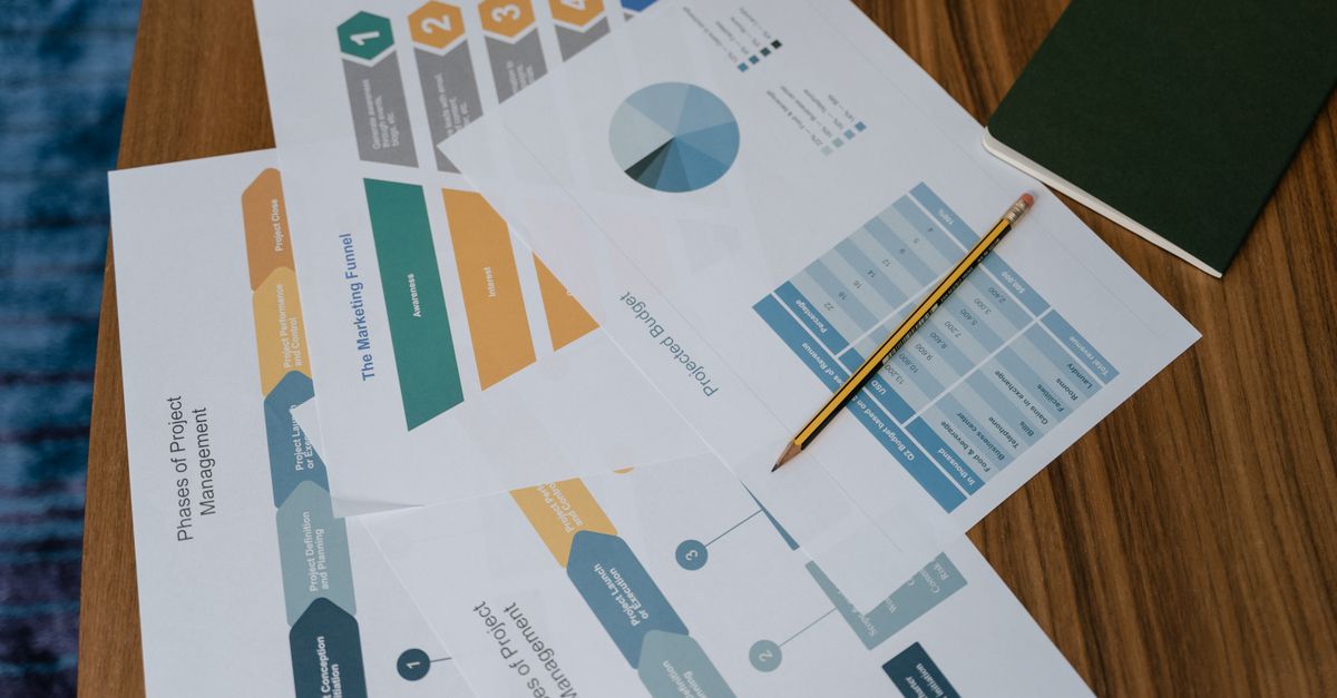 Content That Converts: Proven Strategies for Social Media Marketing in Singapore City Center Overhead view of project management documents and charts on a desk with a pencil.