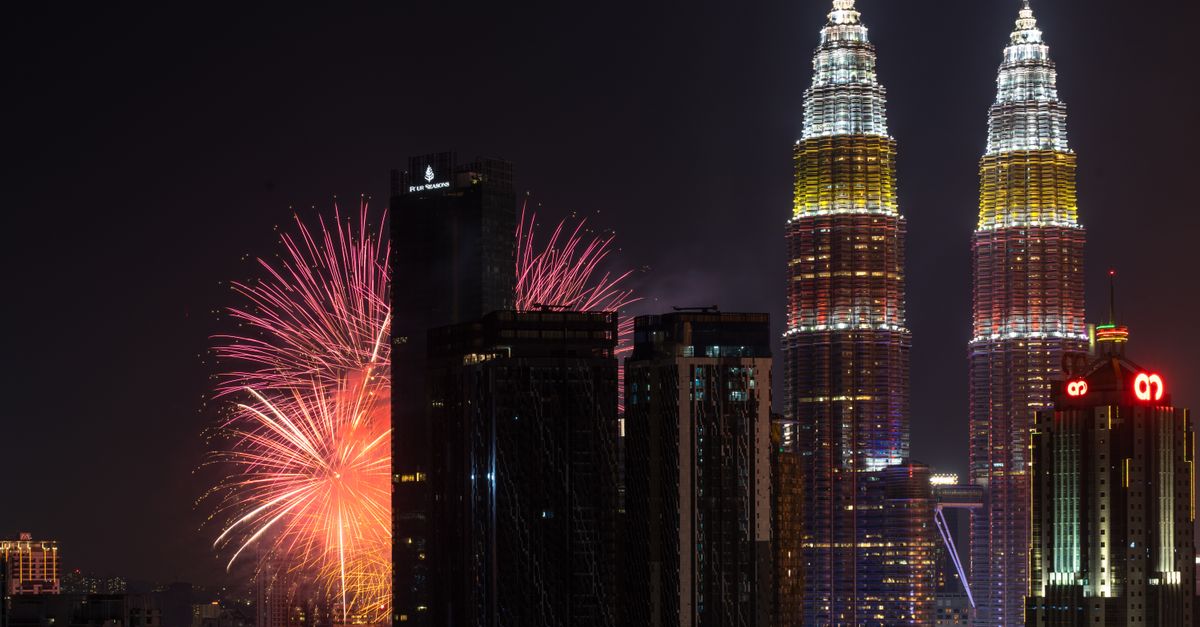 Spectacular fireworks light up the night sky over Kuala Lumpur with the iconic Petronas Towers.