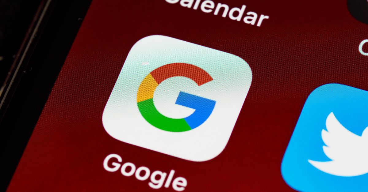 How to Rank on Google AND Get Cited by AI: SEO, GEO & AEO Guide for New York Businesses Macro view of a smartphone displaying Google and other app icons on the home screen.